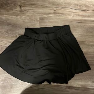 Black skirt that has shorts underneath it.